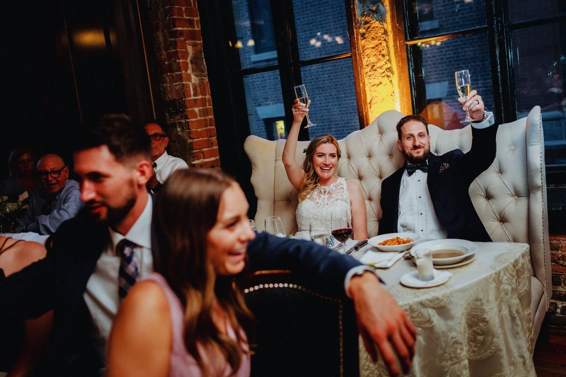 couple raising glasses at old montreal wedding venue