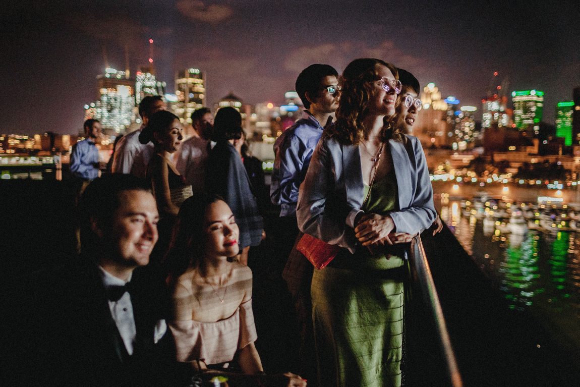 wedding guests at night with Montreal skyline