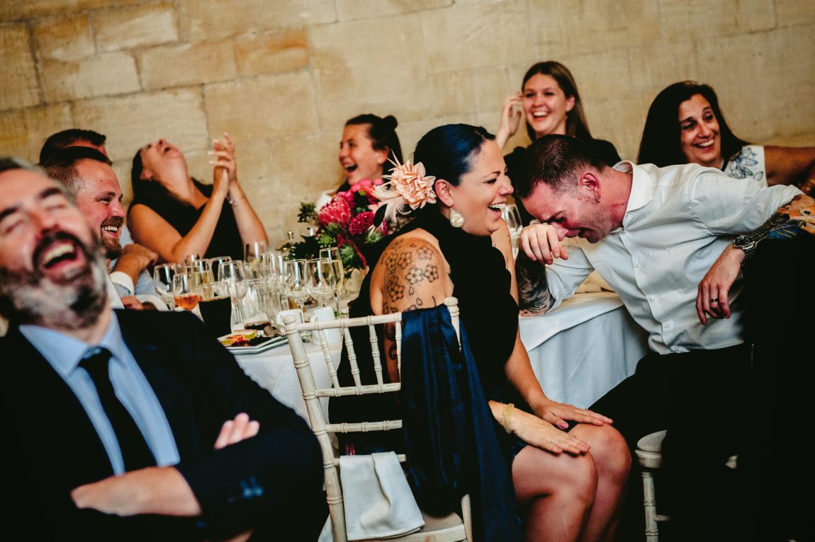 wedding guests laughing at reception