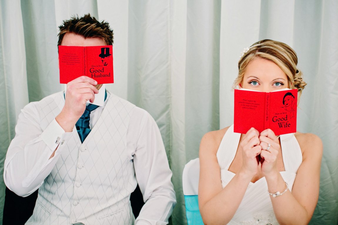 fun photo of bride and groom with good husband and good wife books